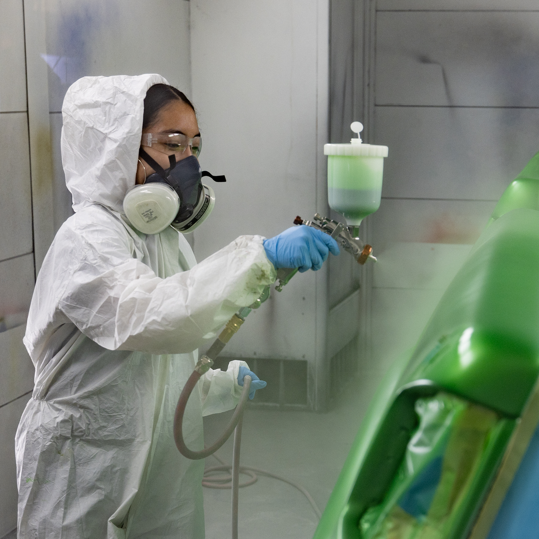 auto collision & management technology student painting in the paint booth in Waco.