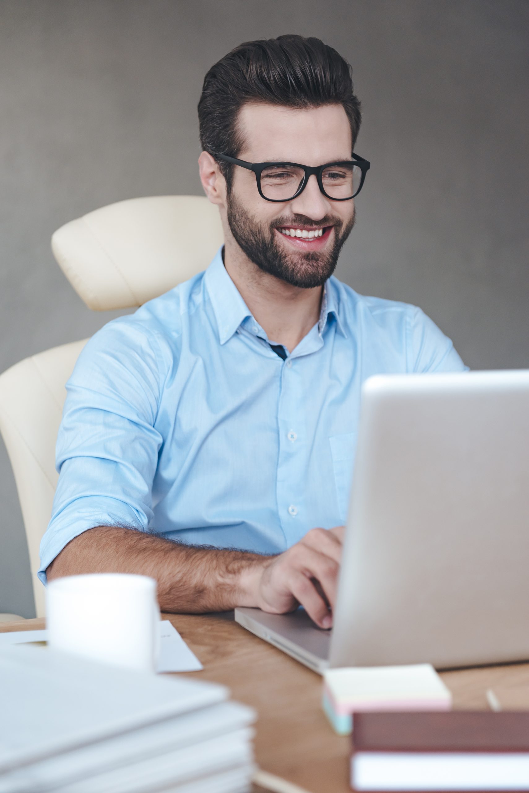 Caucasian male sitting at a laptop