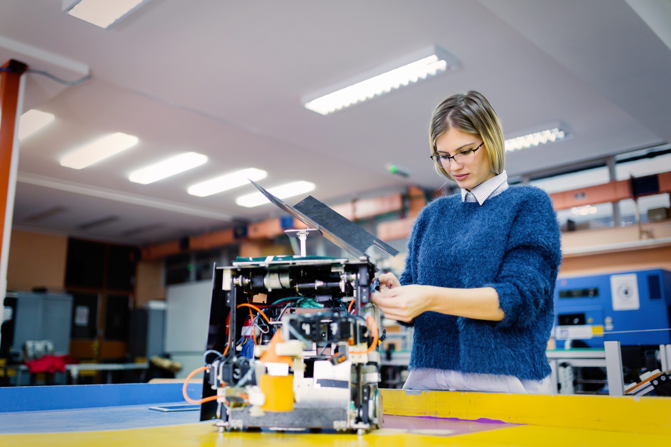 Caucasian female technician working on technology