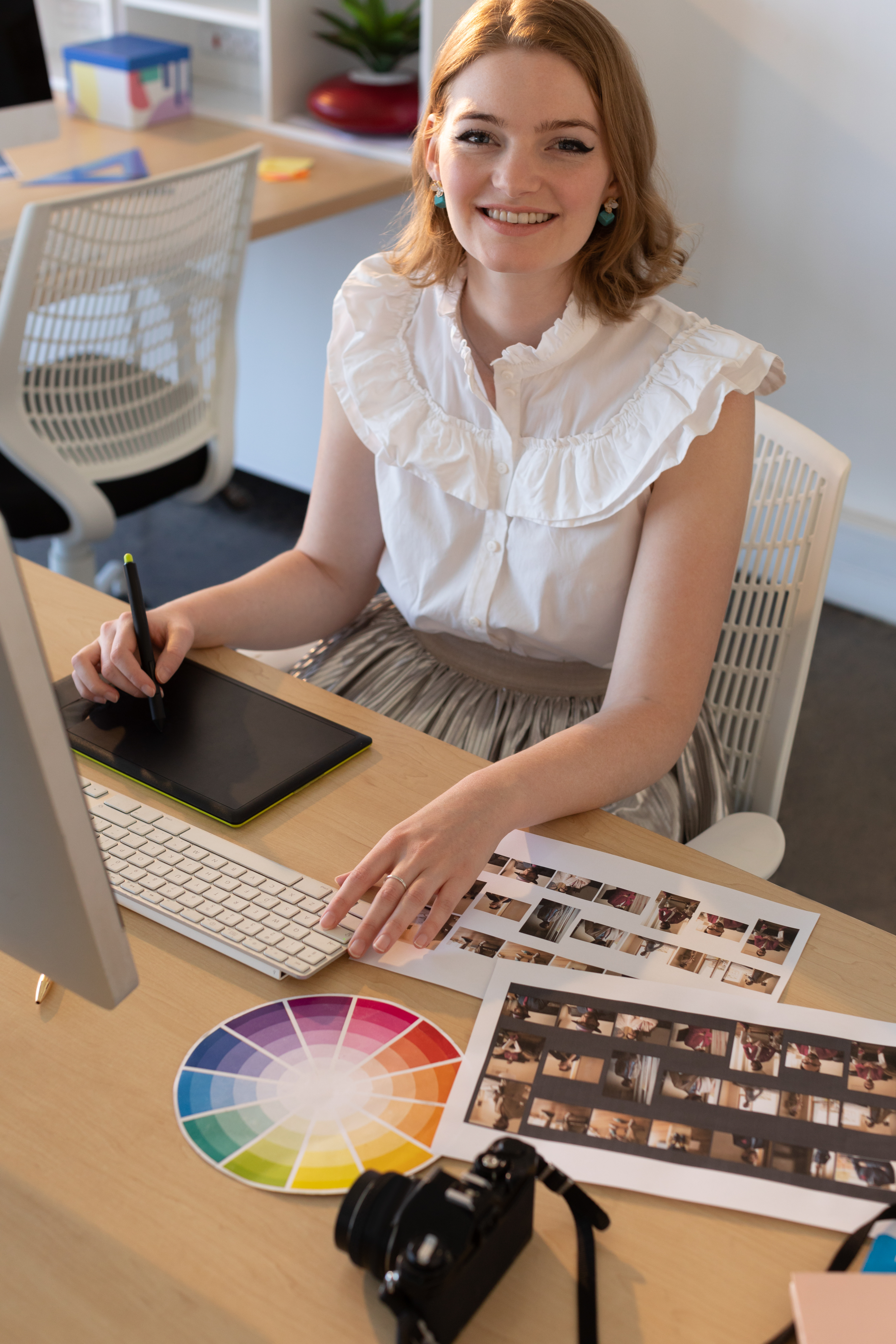 Caucasian female graphic designer on tablet