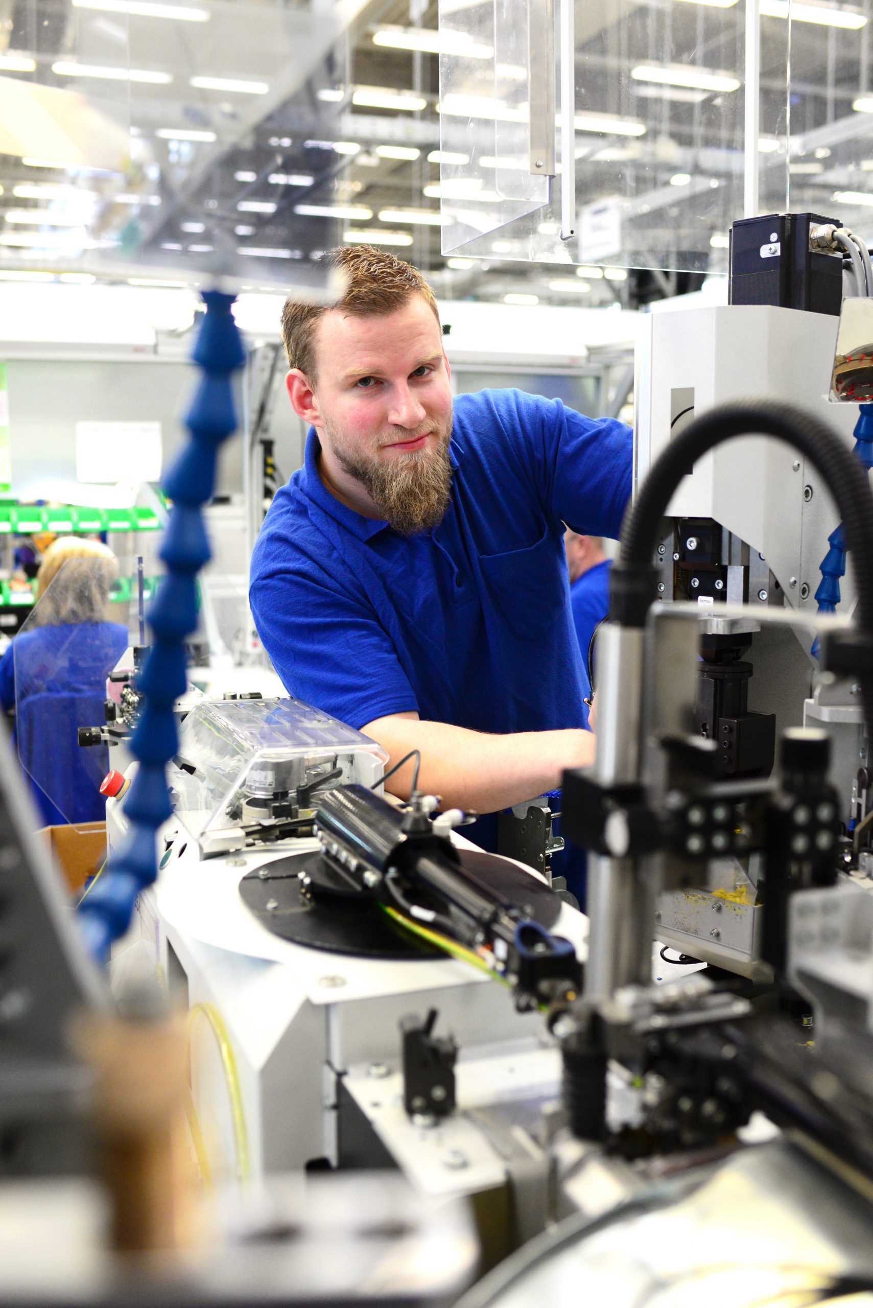 Caucasian redhead male working on machine