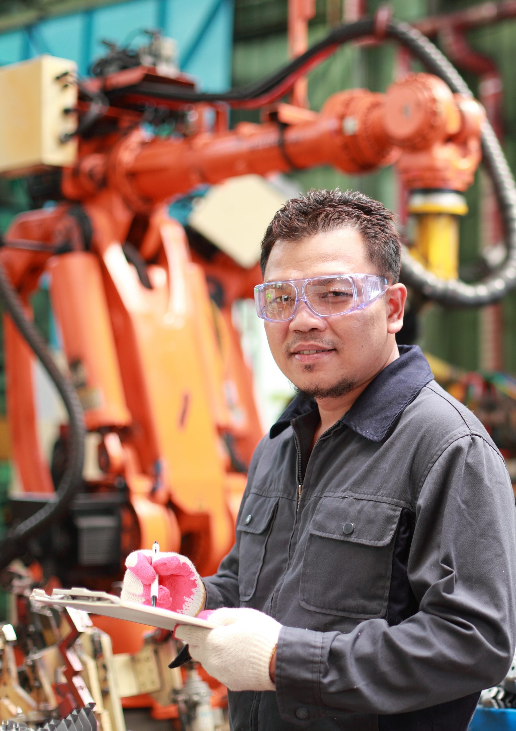 Hispanic male worker holding clipboard