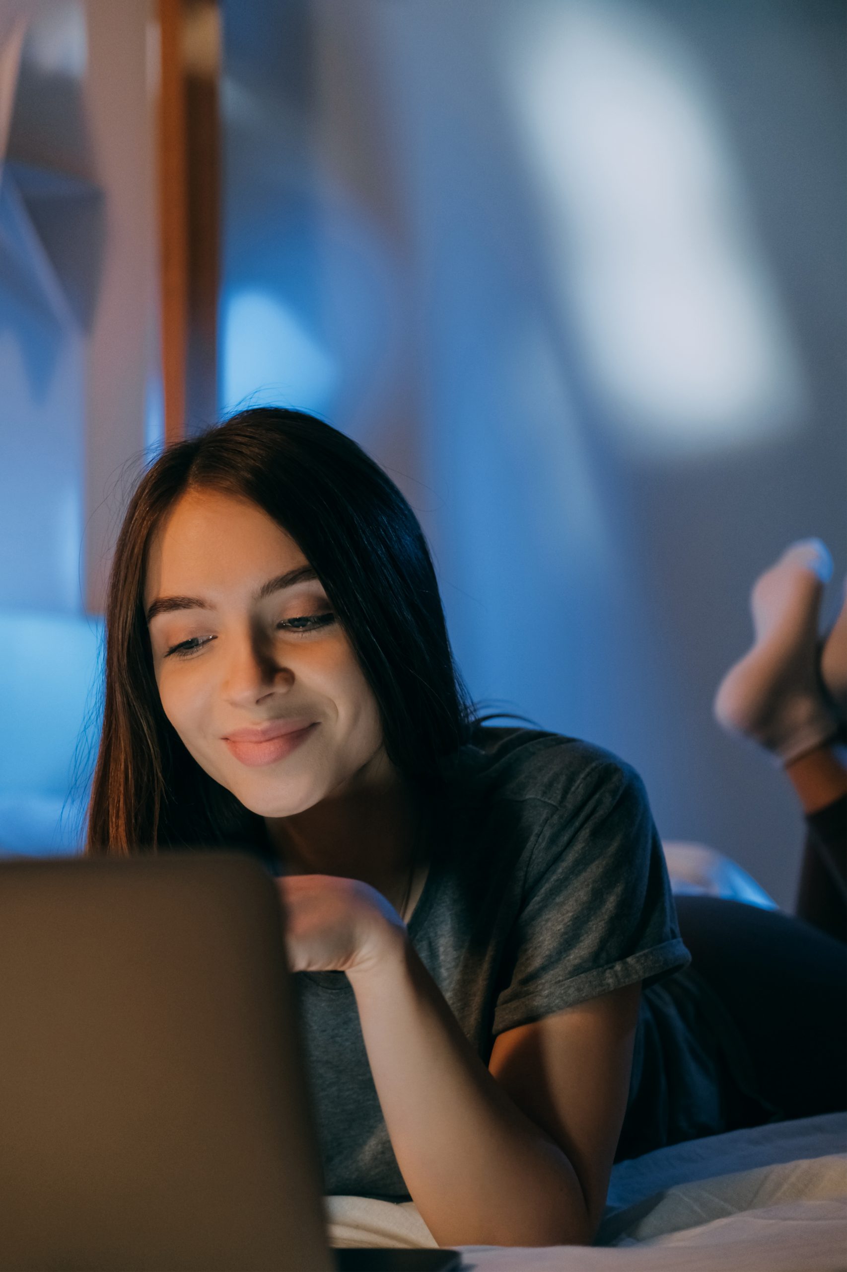 Hispanic female on bed with laptop | Clery Act