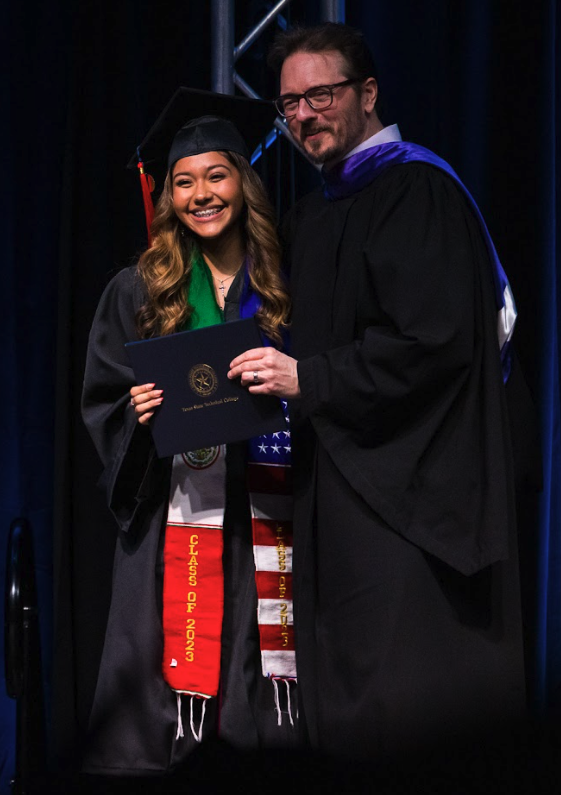 Fort Bend County graduate, Daniela, accepting her diploma.