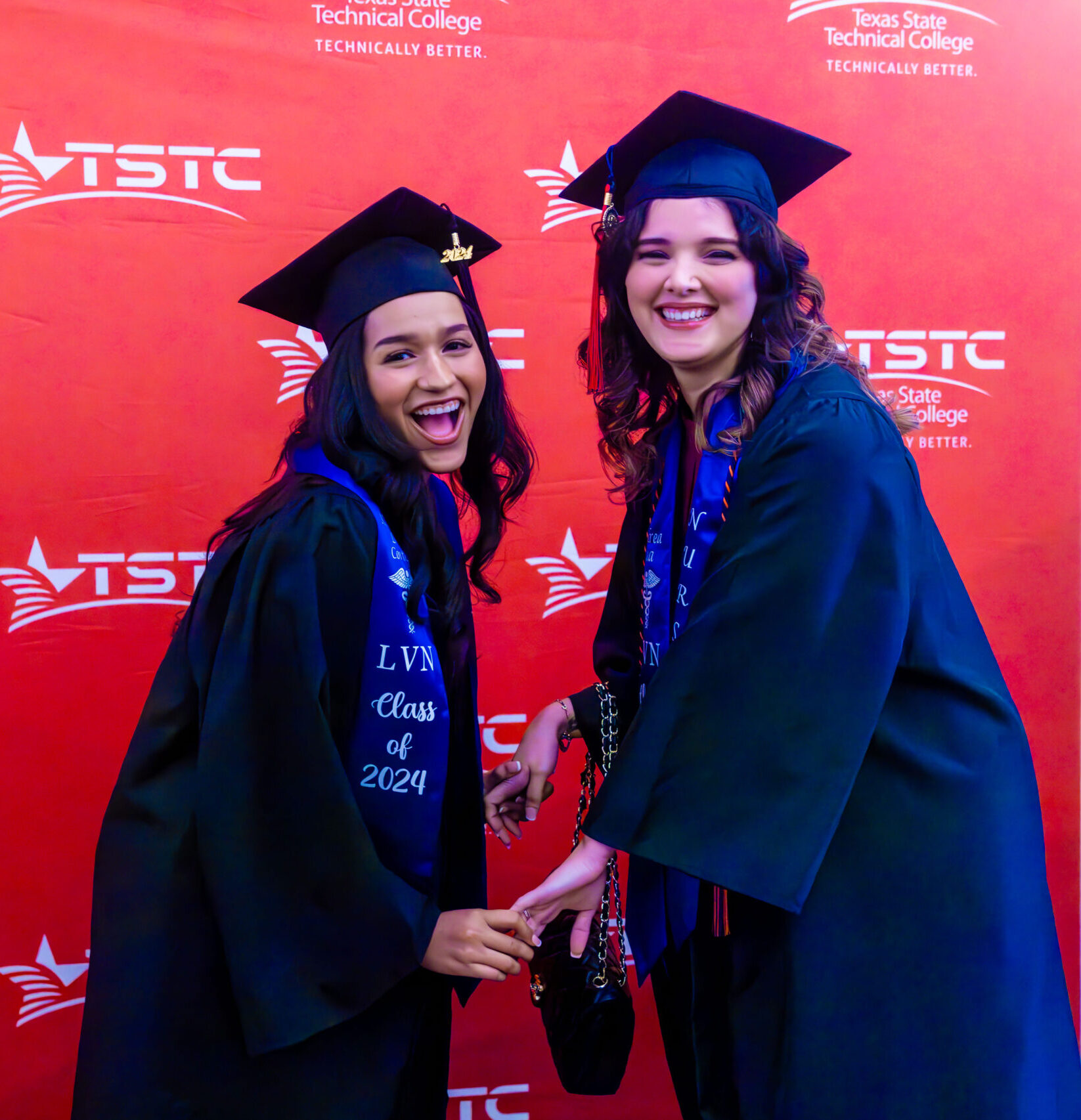 Two female graduates at the Summer 2024 commencement ceremony in Harlingen, Texas.