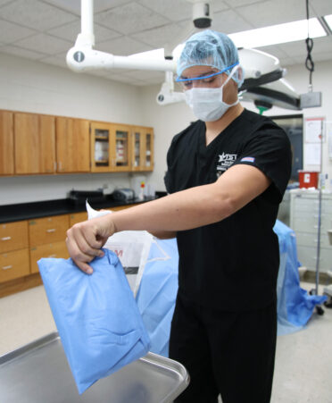 TSTC first-semester Surgical Technology student David Sanchez practices a gowning exercise during a recent lab session.