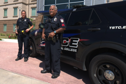 Two officers stand in front of Griffith Hall in Waco.