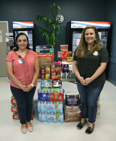 Cynthia Morley (left), a TSTC Advocacy and Resource Center coach, and Katie Hodge, the Junior League of Harlingen's Done in a Day committee chair, are shown with items recently donated by the Junior League to TSTC's food pantry.