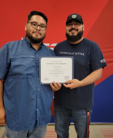 Juan Avila (right), a TSTC Maritime Welding instructor, hands Juan Martinez his NCCER Maritime Welding Level 1 certificate of completion during TSTC’s recent Workforce Training and Continuing Education graduation ceremony.