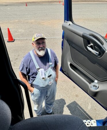 A commercial truck driver’s seat is eight feet off the ground. TSTC Professional Driving Academy student David Denham is shown here to demonstrate that distance. (Photo courtesy of TSTC.)