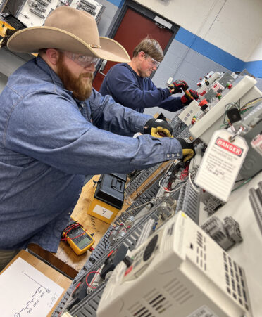 two men working in a electromechanical lab