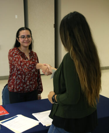 Layla Garcia (left), a TSTC Biomedical Equipment Technology student, is greeted by Ashley Salinas, TSTC’s advisory committee lead for Career Services, during a recent TSTC Career Services Interview Practicum.