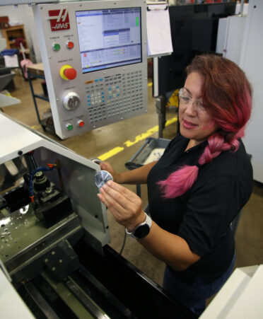 Brenda Valdez Prosise, a TSTC Precision Machining Technology student at the Harlingen campus, trains on a computer numerical control (CNC) lathe machine during a recent lab session.