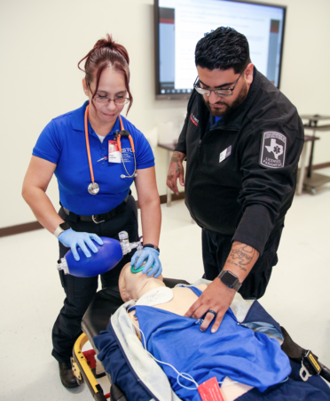 Maria Compian (left), an Emergency Medical Services student at TSTC’s Harlingen campus, practices supplying breathing assistance to a medical manikin with EMS instructor Ede Flores.