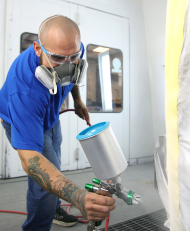 Cristobal Gonzalez, an Auto Collision and Management Technology student at TSTC’s Harlingen campus, uses a paint spray gun to refinish a 2011 Nissan Armada during a recent lab session.