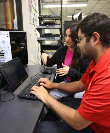 TSTC Cybersecurity students Starla Mendoza (left) and Gabriel Garcia check the status of a password-cracking system while they train for the National Cyber League competition at TSTC’s Harlingen campus.