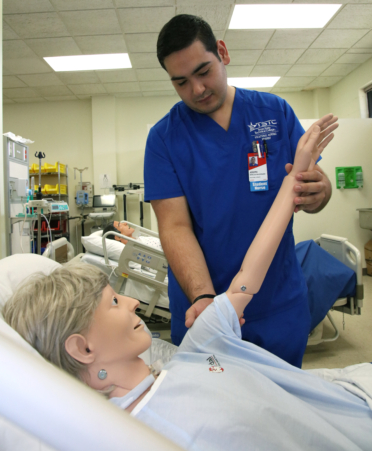 Joseph Ornelas-Maldonado, a Vocational Nursing student at TSTC’s Harlingen campus, maneuvers a medical manikin’s arm to test for upper muscle stimulation during a recent lab session.