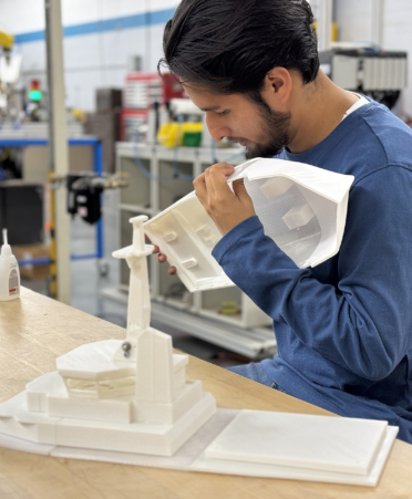 man in blue shirt working on 3D boat