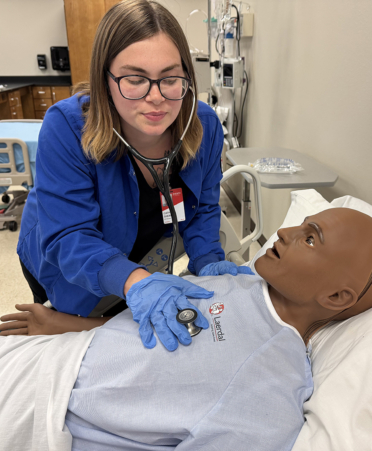 nurse working with medical manikin