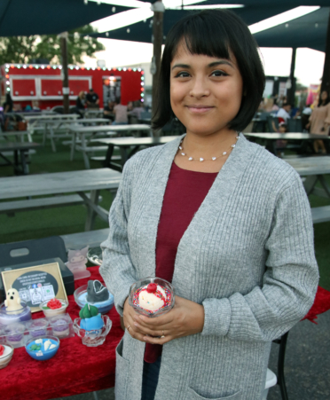 TSTC Business Management Technology alumna Edith Lee Romero displays her candles for a market at The Moon Rock in Harlingen that she recently organized and hosted.