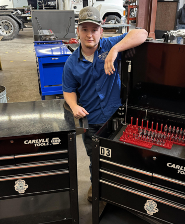 man in blue shirt with tool boxes