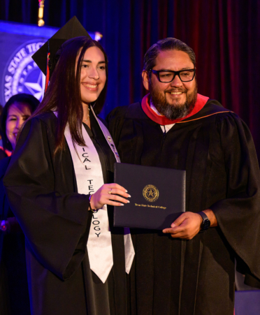 Eladio Jaimez (right), provost at TSTC's Harlingen campus, presents Zoe Betancourt with her Associate of Applied Science degree in Surgical Technology during TSTC’s Fall 2024 Commencement.