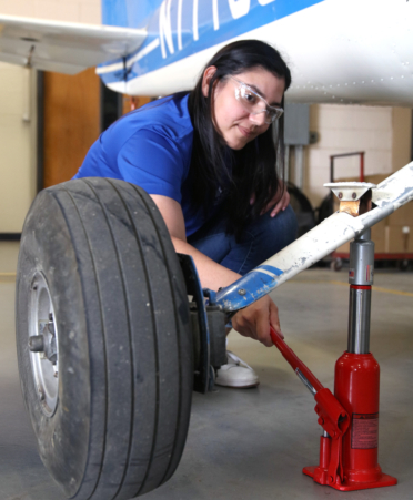 Tania Valdez, an Aircraft Airframe Technology student at TSTC’s Harlingen campus, removes a tire from a Cessna 150 during a recent lab session.