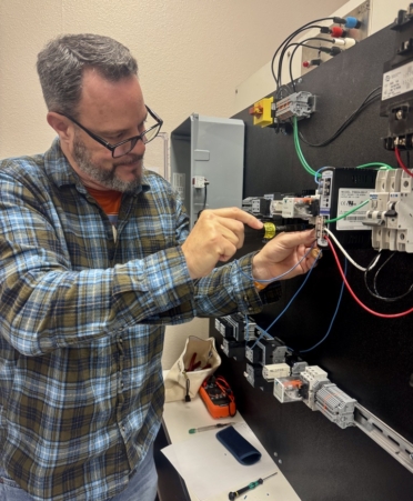 Johnathan Gaither, an Automation and Controls Technology student at TSTC’s Marshall campus, wires a motor control circuit during a recent lab session. (Photo courtesy of TSTC).