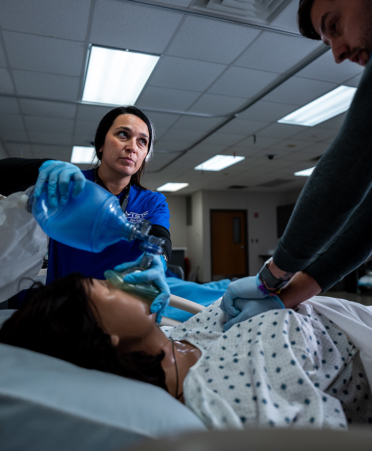 nursing students working with a medical mamnikin