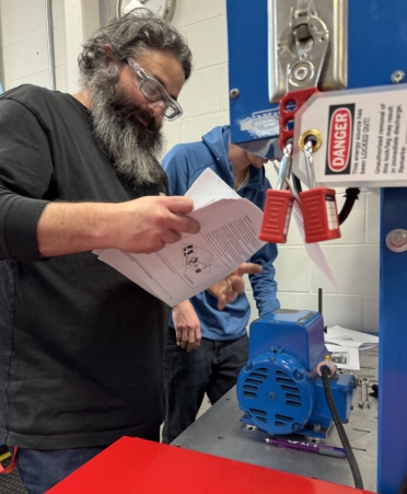 TSTC Industrial Systems student Robert Hernandez works with a partner on a lab assignment.