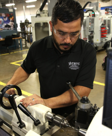 Jose R. Garcia, a Precision Machining Technology student at TSTC’s Harlingen campus, uses a high-speed lathe to cut steel during a recent lab session.