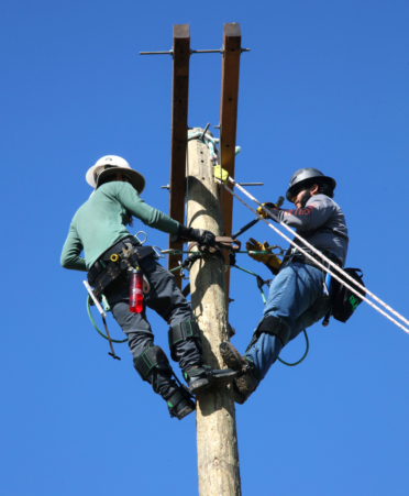 TSTC Electrical Lineworker and Management Technology students Charles Bannwarth (left) and Alec Gonzalez install a double crossarm during a recent lab session at TSTC’s Harlingen campus.