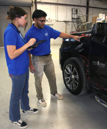 TSTC Auto Collision and Management Technology students Jessica Reyna (left) and Braulio Pena review markings for a refinishing project on a pickup truck during a recent lab session to prepare for the SkillsUSA Texas Postsecondary Leadership and Skills Conference April 2-5 in Corpus Christi.